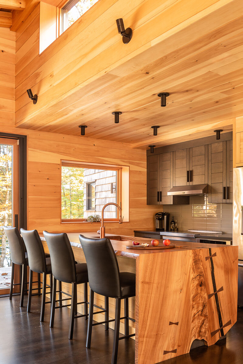  Upstairs kitchen with custom cabinetry and island by Robie Wentworth. 