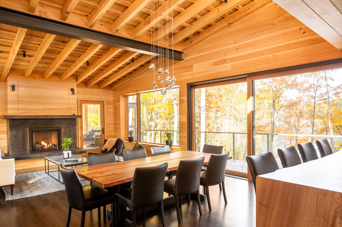 The wood’s warmth made black a natural contrast for the furnishings. Robie Wentworth made the dining room table with a live edge.