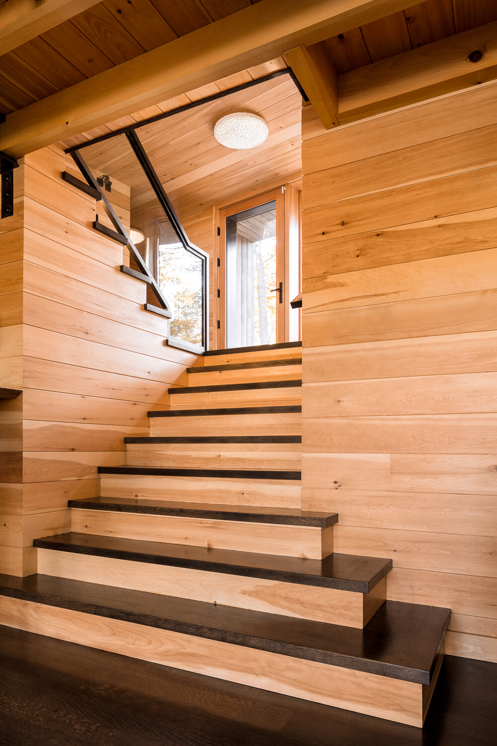  Stairs from the foyer into the ground-floor great room were made to be visually simple and open. The treads are white oak and the risers are pine. 