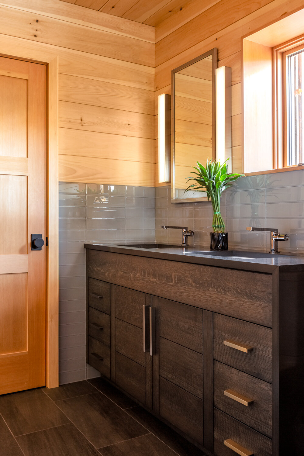  For consistency, the same tiles (from Old Port Specialty Tile) on the bathroom wall and stair on the custom vanity were used in the kitchen. 