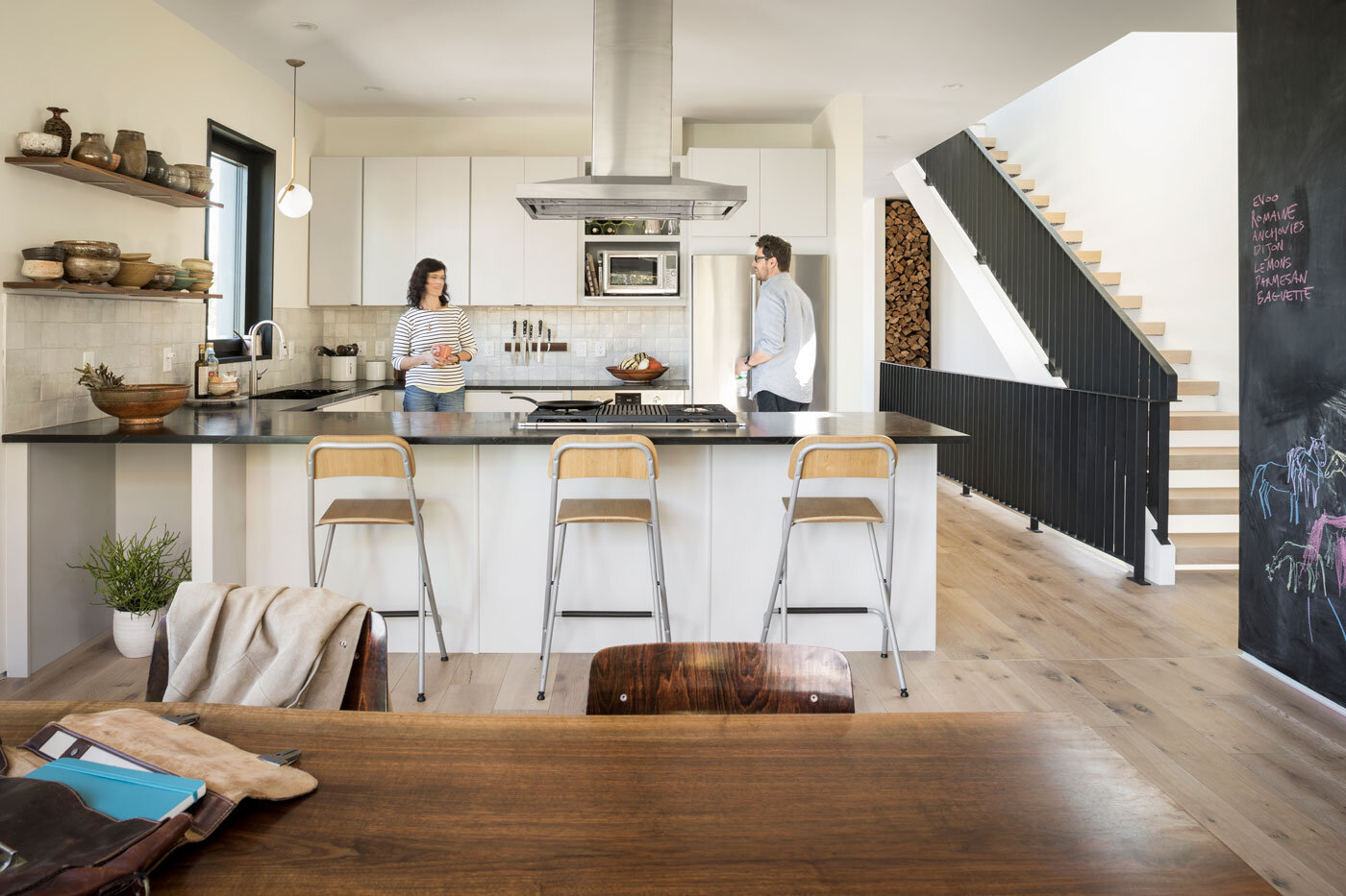  Soapstone countertops and zelige tile from Clé and illuminated by a pendant light by Michael Anastassiades for FLOS. Shelf pottery by Matt’s mother. Cabinets by Heartwood Kitchen &amp; Bath Center. 