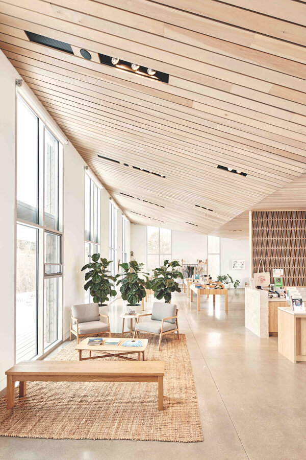 White oak benches designed by MAAM and made by GKS Furniture Maker join chairs from Article in the sitting area.