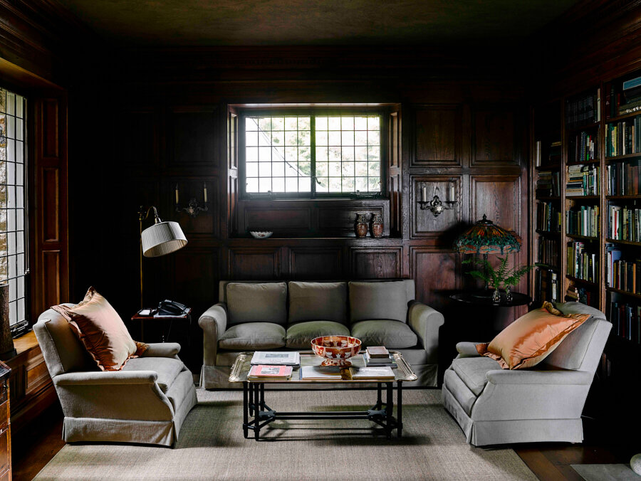 The library, a favorite room of Martha’s, is filled with books by Maine authors. Original walnut paneling and leaded windows give the room a classic, austere beauty.