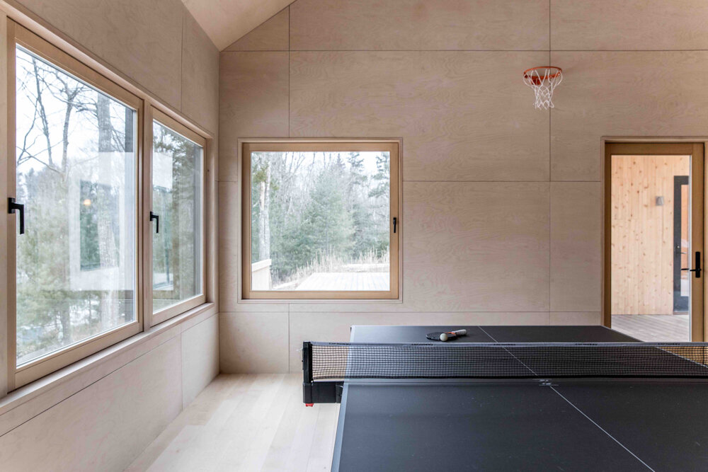  The “dojo” space above the garage hosts table tennis and exercise. During the pandemic, Scott and Julie also used it as a “decontamination” space after shifts. 